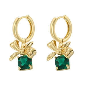Close-up of golden bow earrings with square green gemstone in claw setting