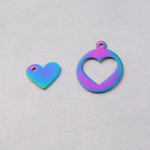 Macro detail of rainbow iridescent stainless steel hollow heart pendants for DIY jewelry