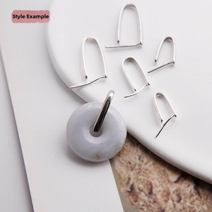 Macro detail of S925 sterling silver pinch bails with a lavender jade pendant on white