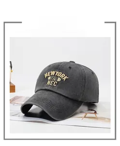 Detailed close-up of vintage charcoal grey cotton baseball cap with yellow embroidery