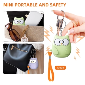 Detail view of owl personal safety alarm with keychain and wrist strap in green and purple