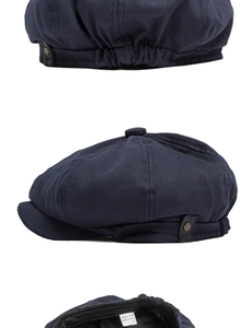 Detail view of navy blue newsboy cap featuring side leather strap and metal rivet accents