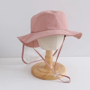 Close-up of pink sun hat with polka dot neck flap and adjustable chin strap