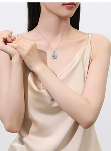 Close-up of S925 silver necklace with aquamarine pendant on a model's neck