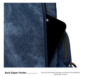 Detail of anti-theft rear zipper pocket on navy denim backpack with smartphone storage