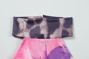 Detail of leopard print halter neckline and floral print fabric on a summer dress