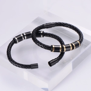 Detail of woven leather bracelets with gold and silver magnetic steel clasps