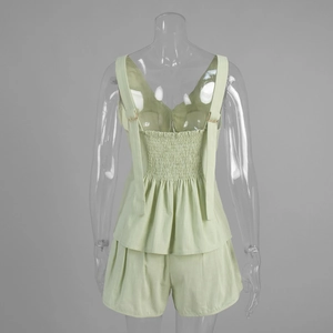 Detail view of cotton set with shirred back design and adjustable gold strap buckles
