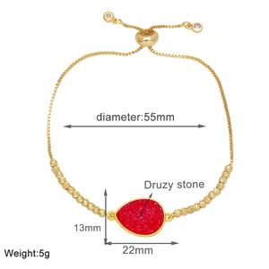 Detail showing 55mm diameter and 22x13mm red druzy pendant on gold-plated bracelet
