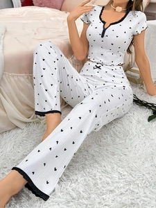 Detail showing white heart print pajamas with black lace trim and ribbed texture fabric