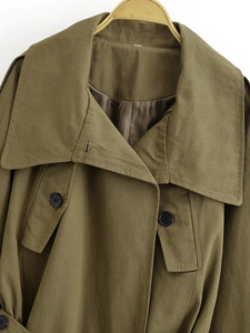 Detail of army green utility jacket featuring classic lapel collar and durable twill fabric