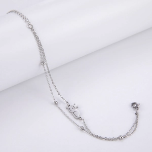 Close-up of double-layer stainless steel bracelet with cat pendant and silver beads