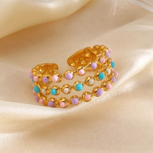 Minimalist three-layer golden open ring featuring colorful beads on silk background