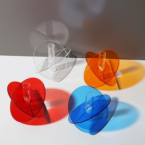 Set of four colorful acrylic geometric vases with vivid shadows and high transparency