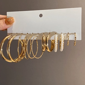 Set of six gold hoop earrings with smooth, textured, pearl, and twisted designs