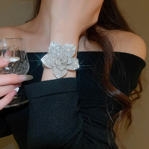 Close-up of sparkling silver floral cuff bracelet with cubic zirconia in lifestyle setting