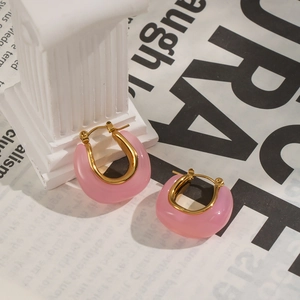 Detailed shot of pink translucent U-shaped earrings with 18k gold plated metal accents