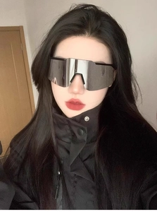Detail of oversized cycling sunglasses with silver mirror lenses and black frame