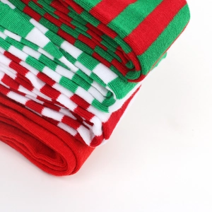 Detailed close-up of knitted Christmas thigh-high socks with red and green stripe patterns