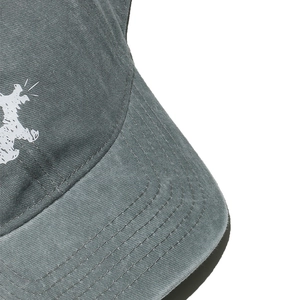 Detailed close-up of washed cotton baseball cap with white dog embroidery and stitching