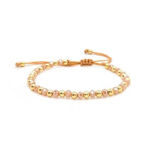 Pink faceted beads and gold spheres on an adjustable braided cord bracelet for women