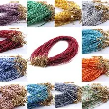 Macro detail of 3mm faceted natural gemstone beads with gold lobster claw clasps in various colors