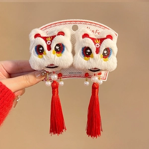 Detail of plush lion dance hair clips with red tassels and pearls for New Year style
