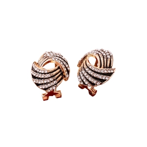 Vintage winged wing stud earrings with gold plating and rhinestones on white backdrop