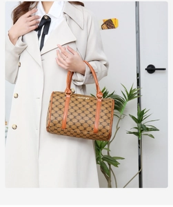 Classic brown Boston bag with M-monogram pattern and golden metal plate detail