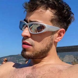 Close-up of Y2K wraparound sunglasses with silver matte frame and mercury reflective lenses