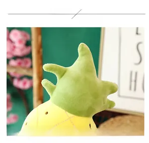Macro shot of pineapple plush toy with soft yellow fabric and green leaf details
