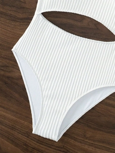 Detail shot of white ribbed swimsuit fabric featuring a stylish waist cut-out design