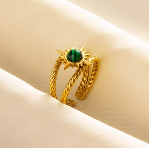 Macro shot of twisted gold 304 stainless steel ring with green striped stone detail