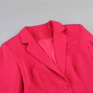 Detail of rose red blazer with notch lapel and fabric-covered button closure