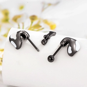Puppy ear black titanium steel stud earrings with white enamel on a white display stand