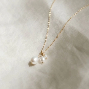 Close-up of minimalist 14K gold plated necklace with three baroque freshwater pearls