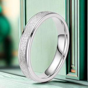 Macro detail of the silver minimalist ring featuring a sandblasted finish and polished inner band