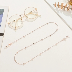 Detail of rose gold beaded eyewear chain with adjustable silicone anti-slip ends