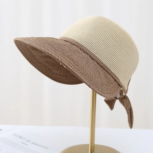 Straw sun hat with two-tone design, cream woven top and brown brim with bow detail