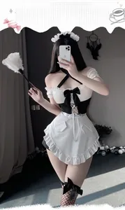 Close-up of maid costume with lace cat ear headband and black bow halter dress