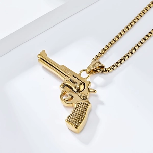 Macro shot of hip hop gold revolver pendant with detailed cylinder and grip texture