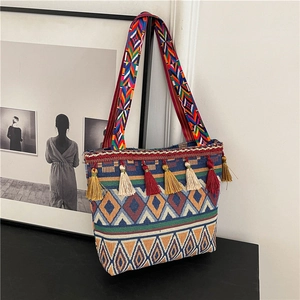 Ethnic style woven shoulder bag with colorful geometric patterns and decorative tassels