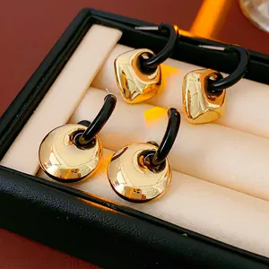 Minimalist geometric gold earrings set with square and round shapes in jewelry box