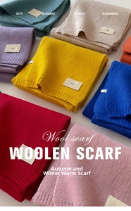 Flat lay of colorful knitted scarves showing thick texture and diverse palette