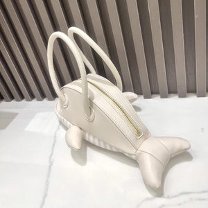 Detail of creative cream-white whale-shaped handbag with smooth PU leather and top zipper