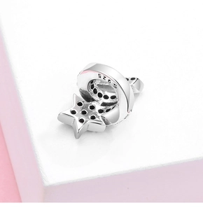 Macro shot of S925 sterling silver star and moon charm with black cubic zirconia details