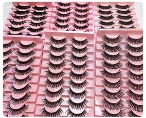 Detail of 10 pairs Russian curl false eyelashes arranged in pink tiered trays