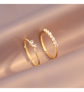 Detailed close-up of double-layer gold rings with marquise and round cubic zirconia stones