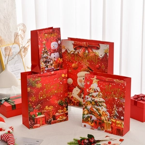 Set of four red Christmas gift bags with gold Merry Christmas glitter lettering