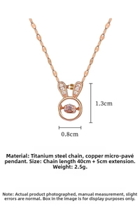 Macro detail of rose gold rabbit ear pendant with dancing pink gemstone and steel chain